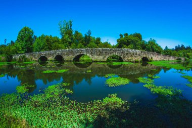 Yazın Portekiz 'deki göl boyunca antik ortaçağ taş köprüsü