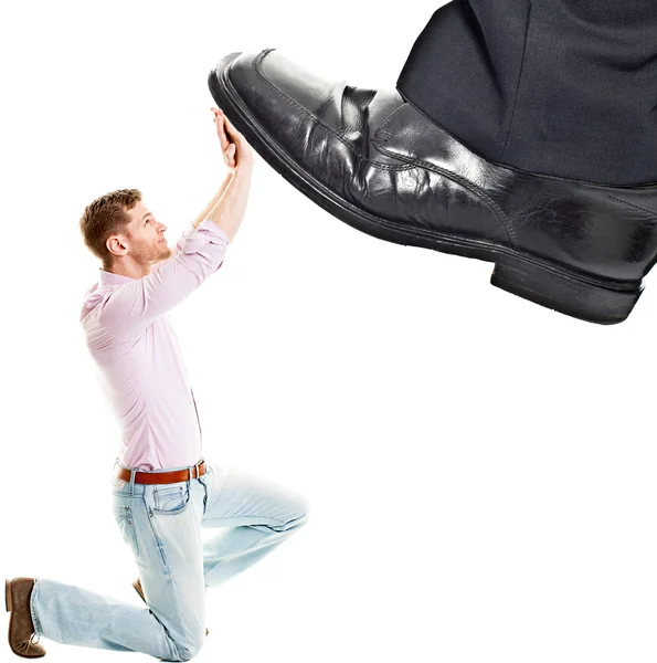 Businessman's foot stepping on tiny businessman — Stock Photo, Image