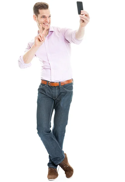 Full length portrait of a happy young man showing a peace sign a — Stock Photo, Image