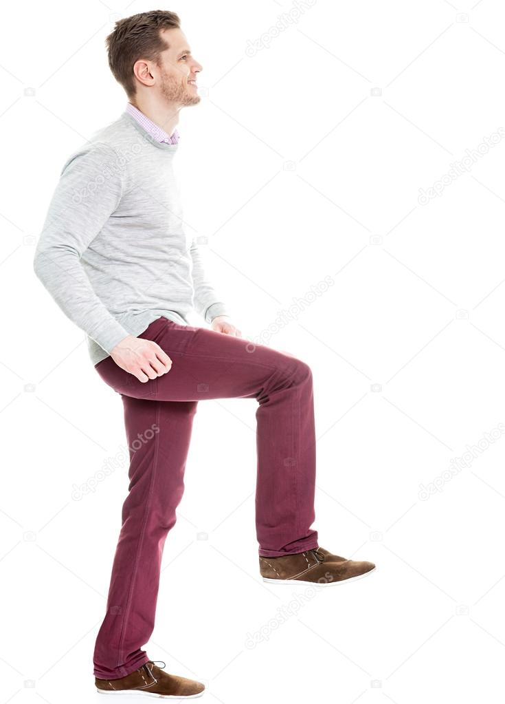 Young man making a step - isolated on white background