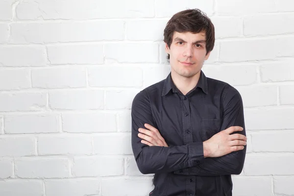 Young man and brick wall — Stock Photo, Image