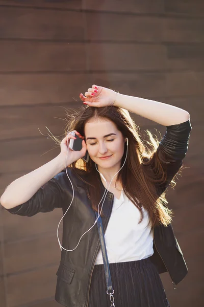 戴着耳机在城市年轻漂亮时髦女人听音乐. — Φωτογραφία Αρχείου
