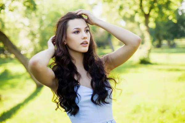 Retrato de uma bela jovem mulher caucasiana em um jardim de primavera . — Fotografia de Stock