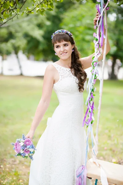 Beautiful bride and swings — Stock Photo, Image