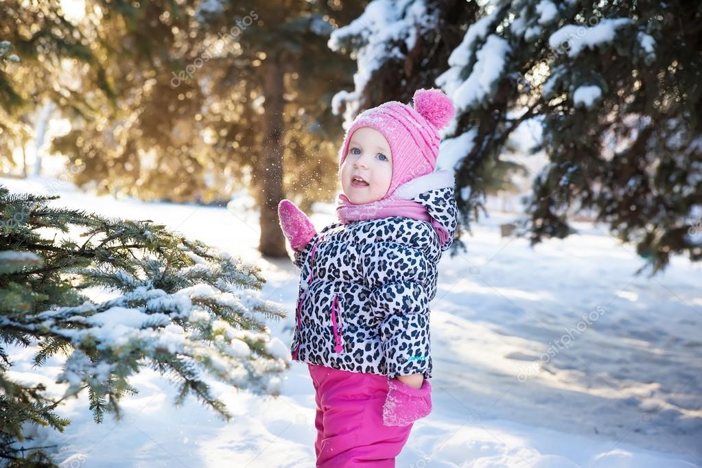 portrait of a little girl in a snowy forest