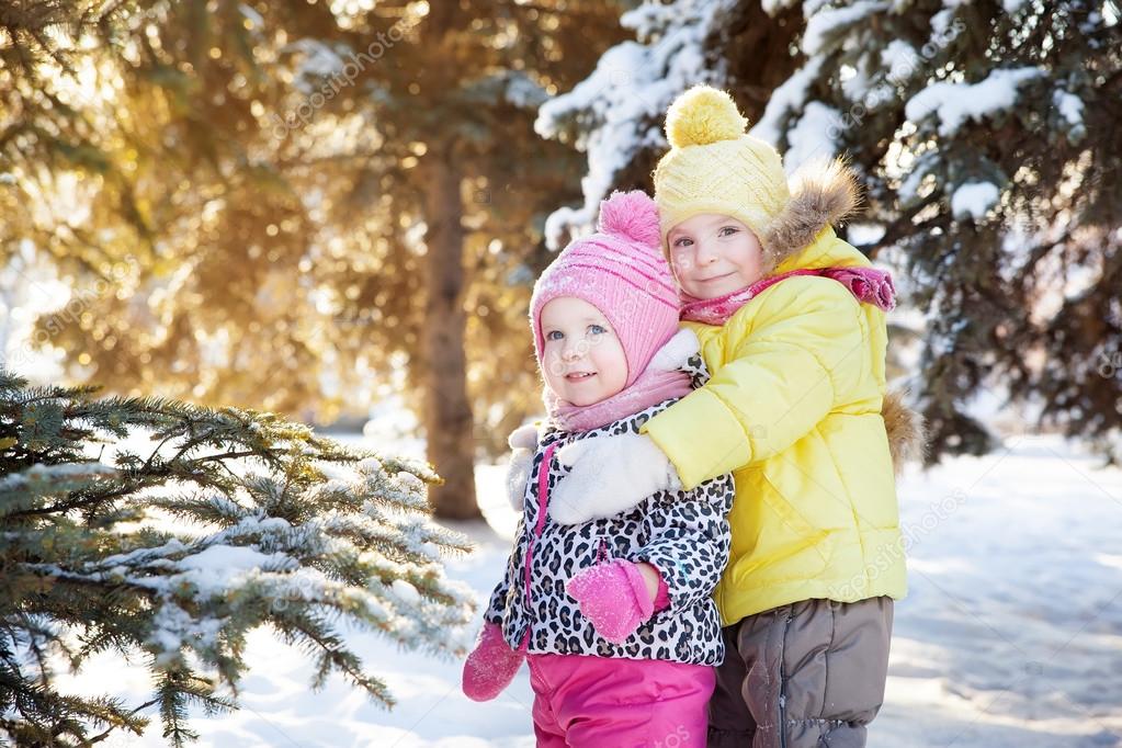 two girls in winter forest