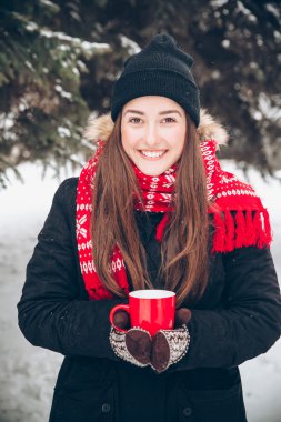 Girl drinking hot tea in the winter forest clipart