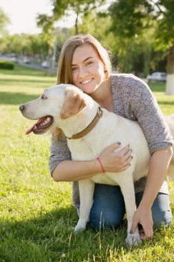 Beautiful woman with her dog. Labrador retriever