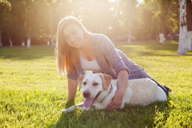 Beautiful woman with her dog. Labrador retriever