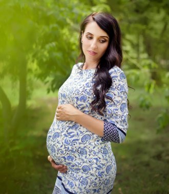 Parktaki güzel hamile kadın.