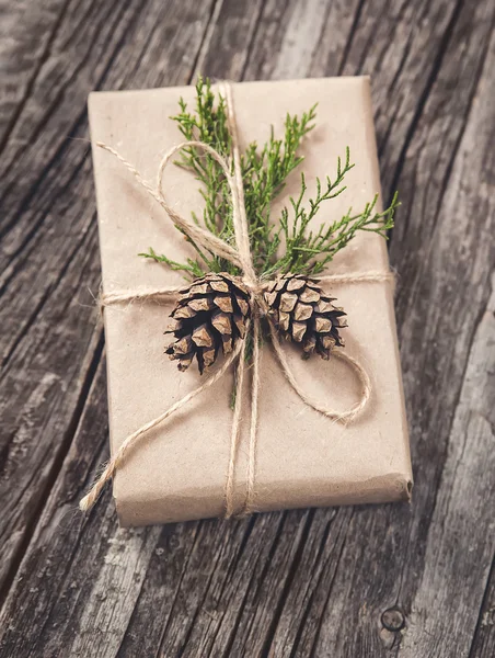 Hand crafted gift on rustic wooden background — Stock Photo, Image