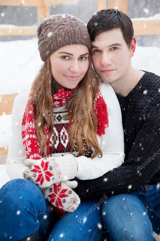 young couple in love enjoying a walk in winter park