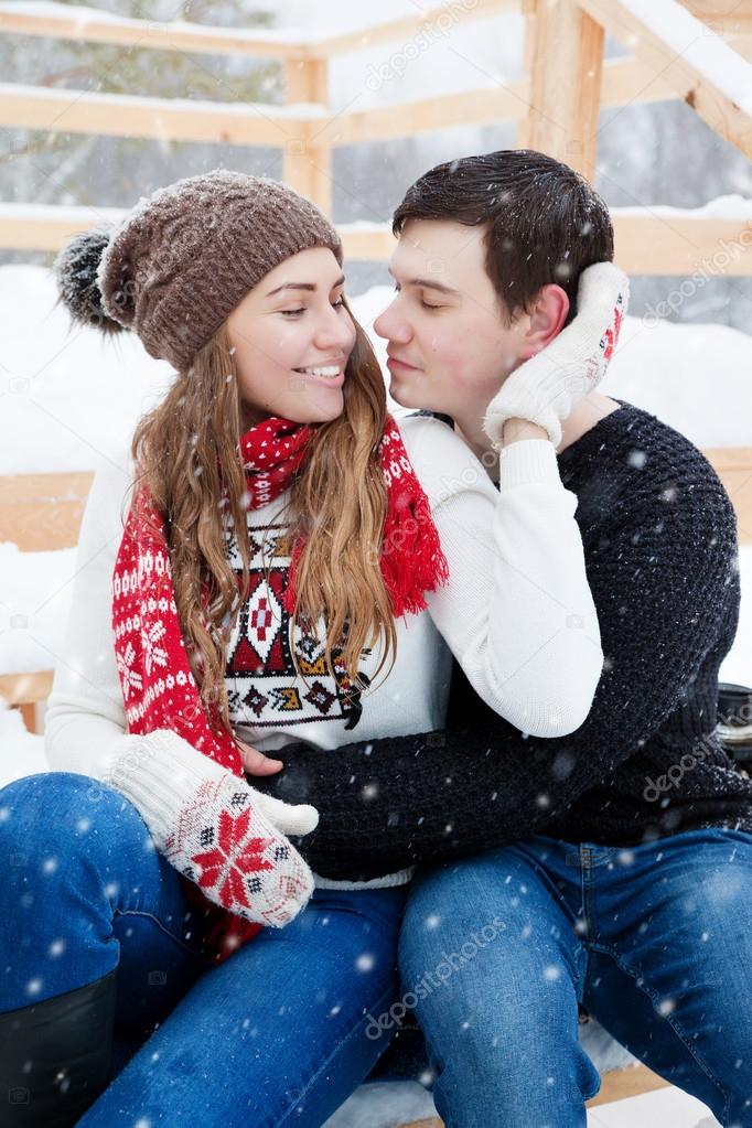 young couple in love enjoying a walk in winter park