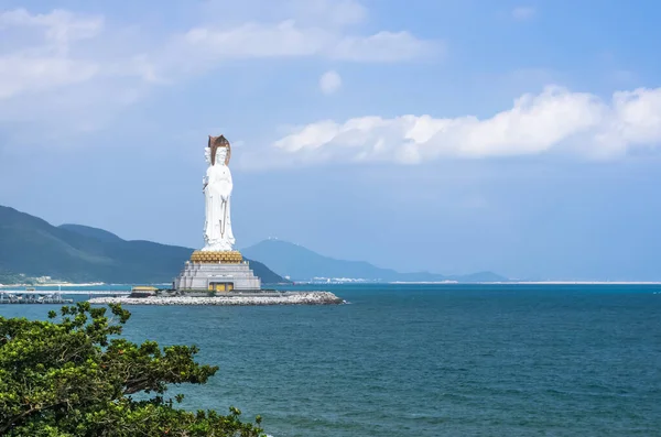 Sea view of statue of goddess Guanyin on the territory of Buddhist center Nanshan in sunny day