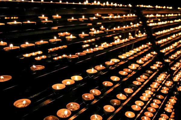 Candles in several rows in the church Stock Picture