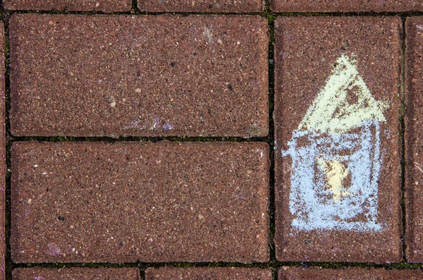 Childish chalk drawing of a house on a brick pavement — Stock Photo, Image