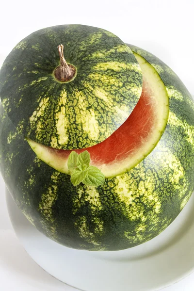 Fresh green watermelon with cocktail straw and mint leaves isolated on white background — Stock Photo, Image