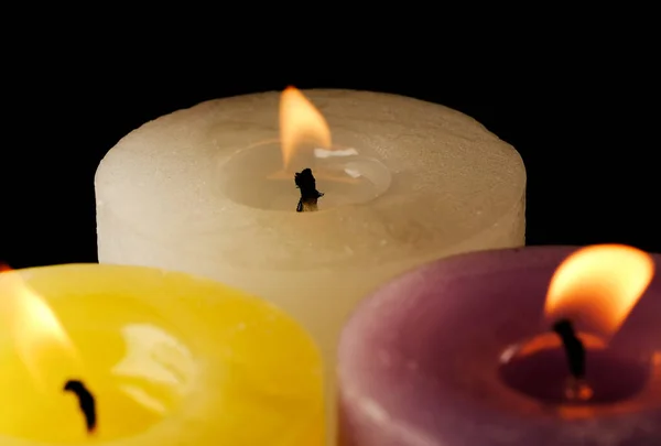 Three Thick Commemorative White Yellow Red Candles Burning Black Background — Stock Photo, Image