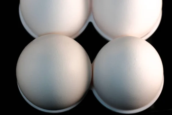 Four White Raw Chicken Eggs Cells Black Background Close — Foto Stock