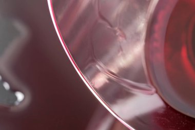 Bir bardak kırmızı şarap siyah yüzeye döküldü. Yakın çekim makro fotoğraf.