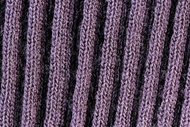 Yünlü bir elbise makinesinin örülmüş parçasının tekstil desenli yakın plan makro fotoğrafı.