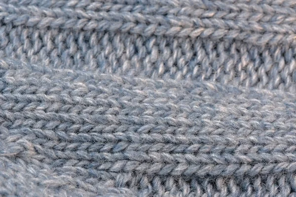 大きな機械編みの男性の毛織のセーターの断片の織物のテクスチャの背景クローズアップマクロ写真 — ストック写真