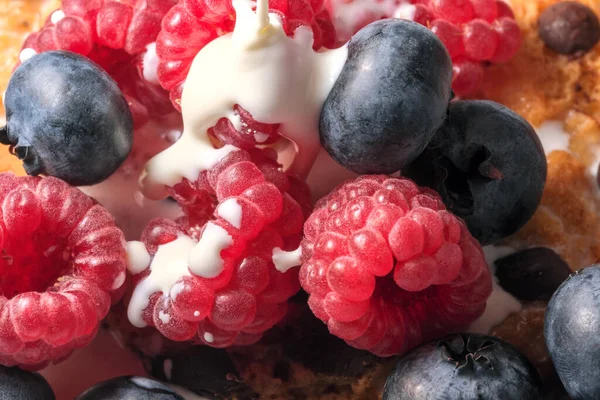 Mix of sweet berries with cream and cookies with chocolate close-up macro photography