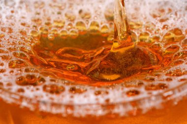 Cam bir mermide hafif bira damlaları ve baloncukları yakın çekim makro fotoğraf.