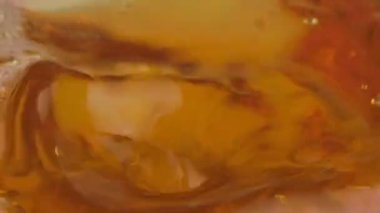 Cam bir mermide hafif bira damlaları ve baloncukları yavaş çekim, makro video klipsi.