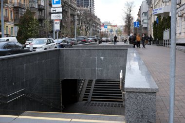 İnsanlar şehrin metro girişinden geçerken kaldırım boyunca yürüyorlar. 24 Kasım 2025, Kyiv, Ukrayna, Shevchenko Bulvarı