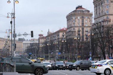 Cars travel through the lively streets of Kyiv with historical buildings nearby. Kyiv, Ukraine. December 12, 2025.