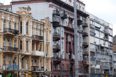 Colorful buildings stand side by side, showcasing a blend of history and modern design. Kyiv, Ukraine. December 12, 2025.