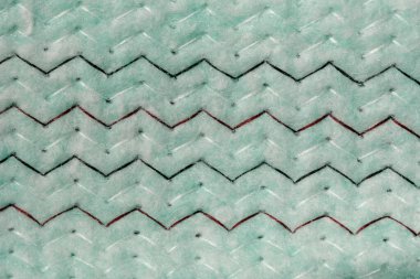 Yumuşak yeşil yüzey zigzag çizgileri içerir, ışığı ve dokuyu yakalar..