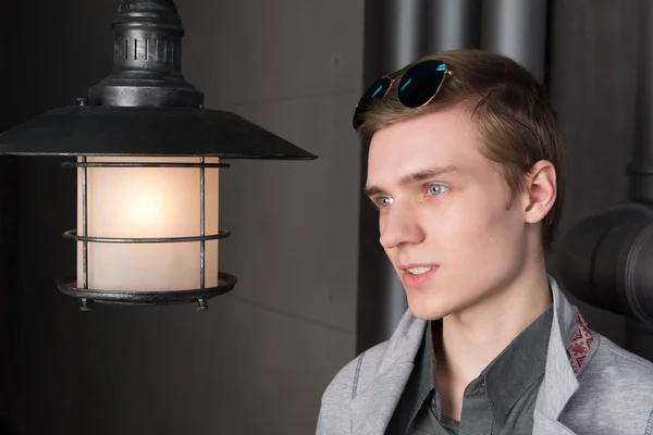 Portrait of a young man with a lantern — Stock Photo, Image