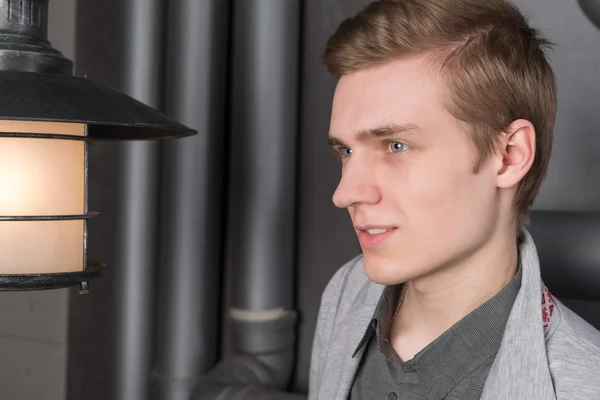 Portrait of a young man with a lantern — Stock Photo, Image