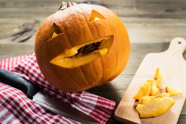 Making jack-o-lantern carved pumpkin for halloween.