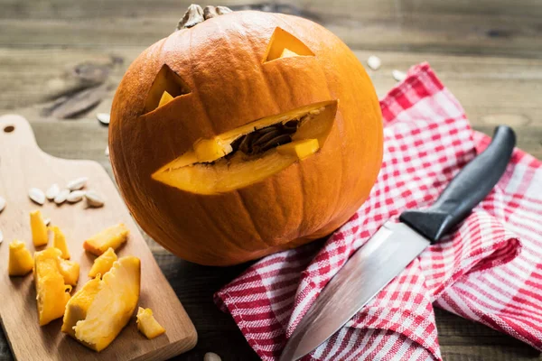 Making jack-o-lantern carved pumpkin for halloween.