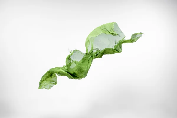 Abstrakt bit av grönt tyg flyger — Stockfoto