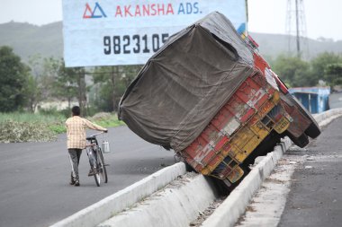 Pune, India - June 27, 2015: An truck that went out of control o clipart