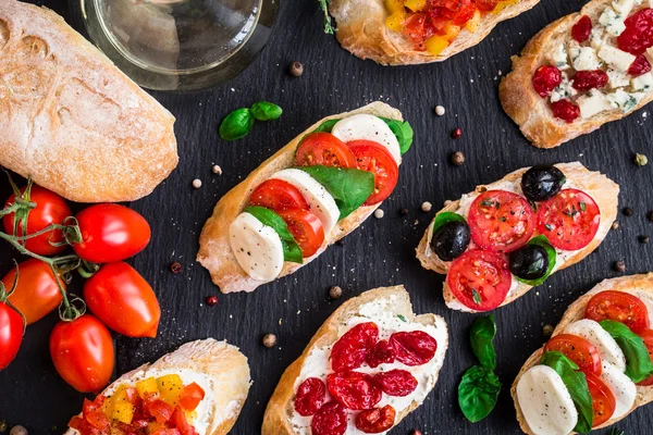 Bruschettas with tomatoes, herbs and olives — Stock Photo, Image