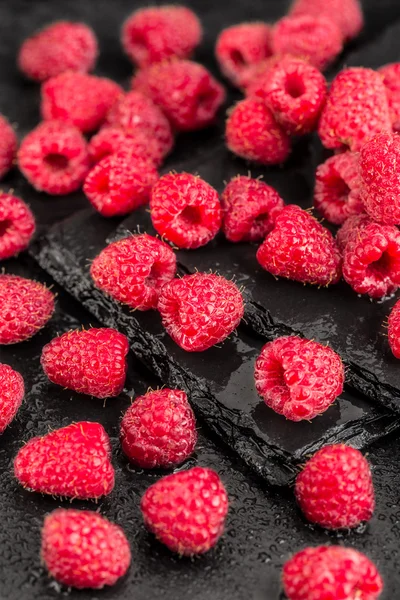 Fresh red raspberries on a slate background — Stock Photo, Image