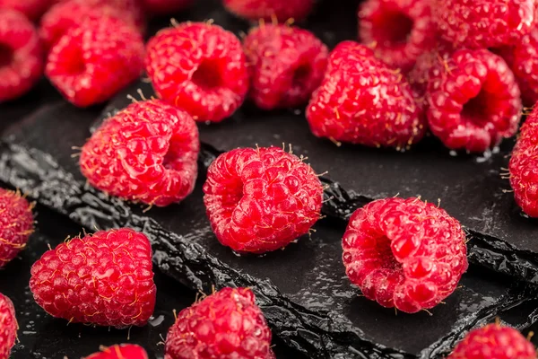 Fresh red raspberries on a slate background — Stock Photo, Image