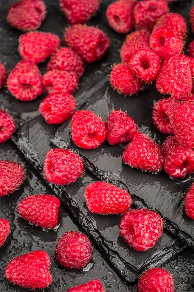 Fresh red raspberries on a slate background — Stock Photo, Image
