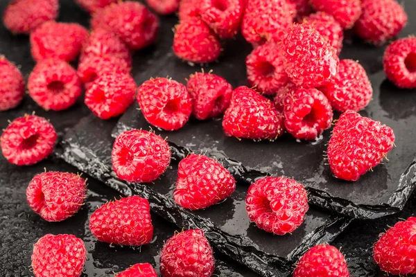 Fresh red raspberries on a slate background — Stock Photo, Image