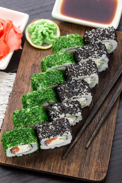 Sushi roll covered with dill and sesame — Stock Photo, Image