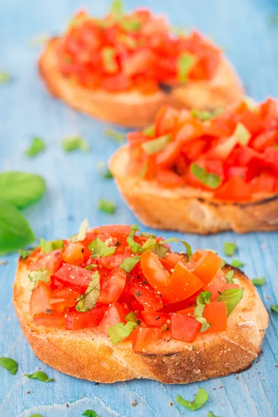 Italian tomato bruschetta with basil — Stock Photo, Image