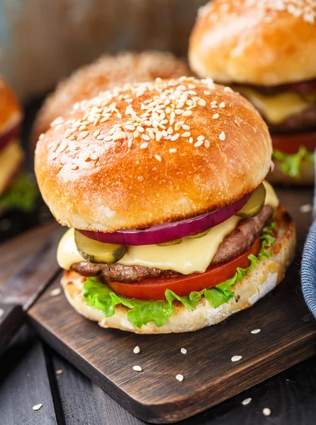 Delizioso hamburger su tavola di legno — Foto Stock