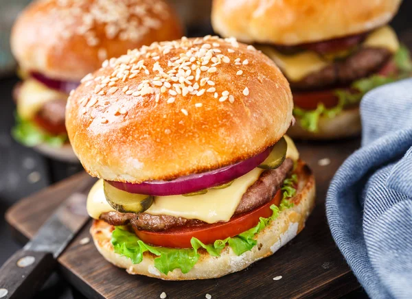 Delicious burger on wooden board — Stock Photo, Image