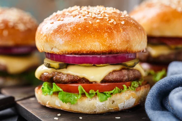 Delicious burger on wooden board — Stock Photo, Image