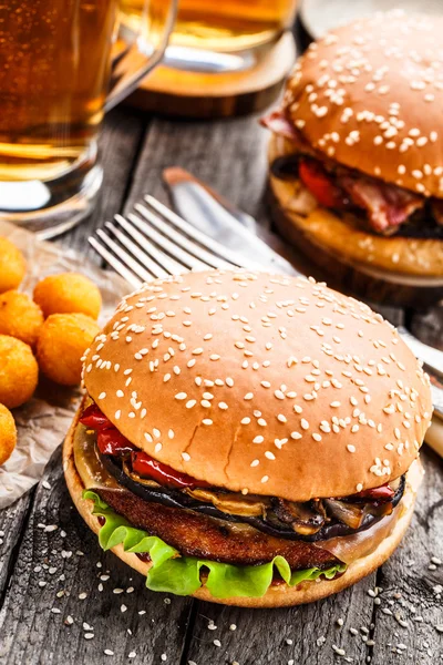 Delicious burger with fried potato balls and beer — Stock Photo, Image